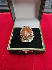 artisan-crafted sterling silver ring features a brown  Stone