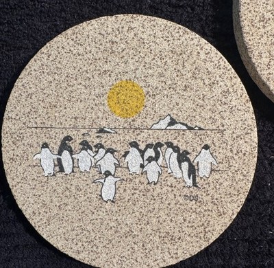 Two-Thirstystone Natural Solid Sandstone Coasters featuring penguins.