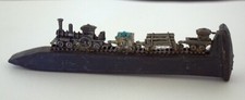 Antique railroad spike Size 6.5" long with attached Coal Mine Train.