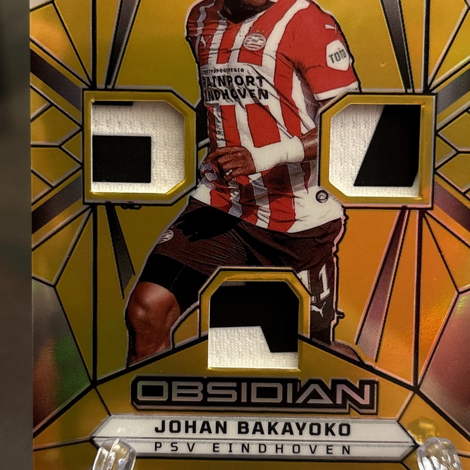 2024-25 Panini Obsidian Johan Bakayoko Triple Patch Gold #1/5 PSV - Imagem 2 de 4