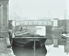 Man mooring a barge by a river bank, Poplar, London, 1905. Barge on- Old Photo