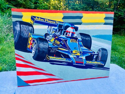 Racing Driver MARIO ANDRETTI seated in his John Player Special Lotus at box before a Formula 1 race Stock Photo
