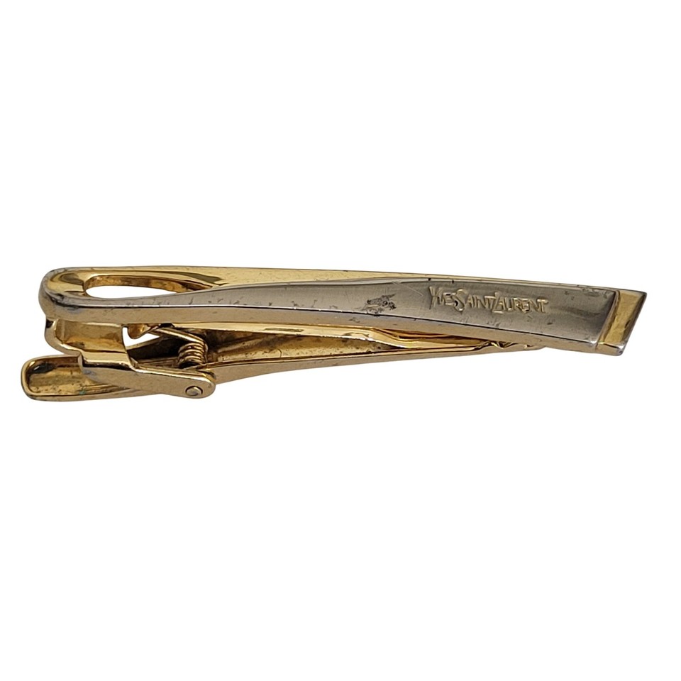 Vintage YSL two-tone tie clip with the original logo — Yves Saint Laurent menswear accessories from this era are legitimately rare and effortlessly cool.