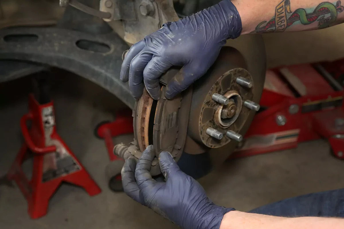 Removing the brake pad from the mount.
