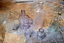 6 - Manganese glass bottles, No stoppers, some scraches, chips, cracks