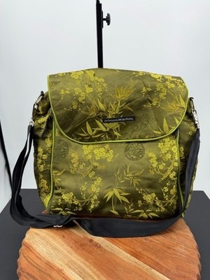 Petunia Pickle Bottom diaper bag in a green, silky, bamboo-themed fabric
