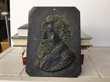 AN ANTIQUE BRASS RELIEF PLAQUE OF CHARLES DICKENS