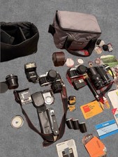 2 Canon AE-1 Lot With Lenses, Film, Accessories. 1 Camera Tested - As Is