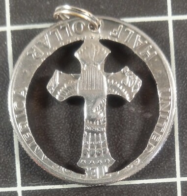 This is a cross hand cut Kennedy half dollar !!