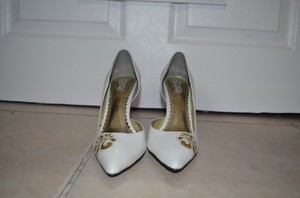 white heels with gold accents