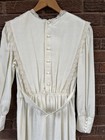 White vintage 70s midi prairie dress with lace neckline, button front, and matching waist tie belt.