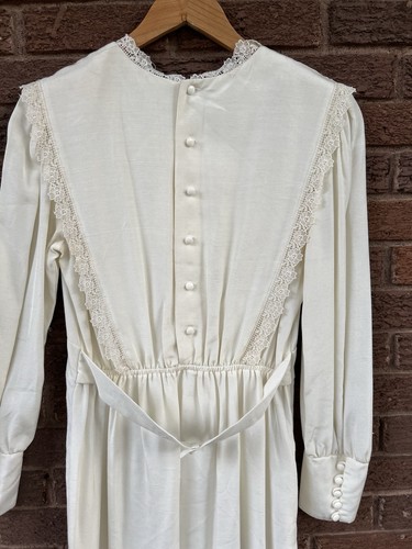 White vintage 70s midi prairie dress with lace neckline, button front, and matching waist tie belt.