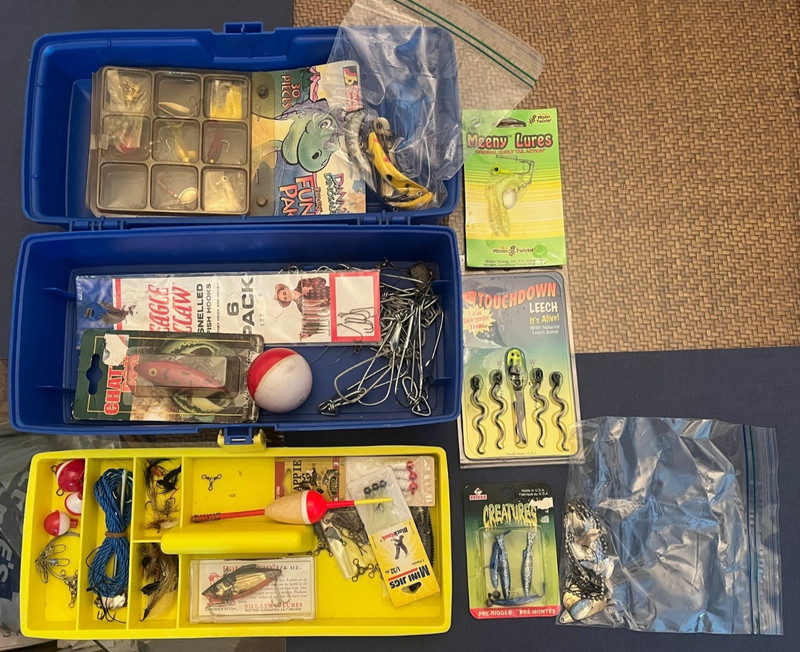 small Plano tackle box full of a variety of tackle and lures