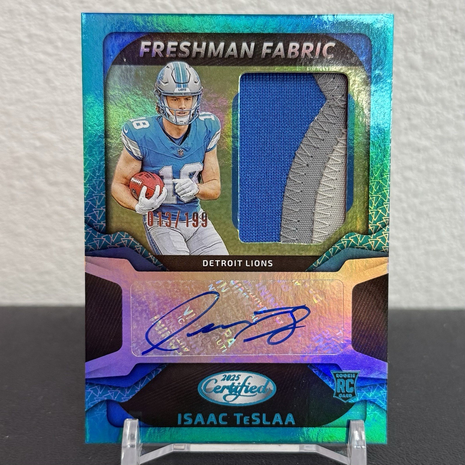 2025 Certified Football Isaac TeSlaa Freshman Fabrics Teal Auto 13/199 #FBC-ITA