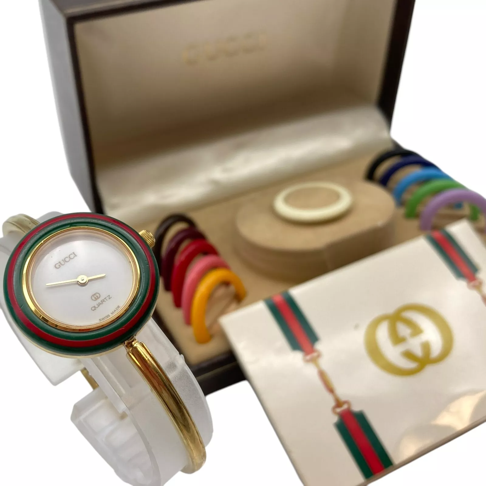 Montre femme Gucci lunette changeante 12 couleurs cadran doré marron en boîte fonctionne 6 1/2