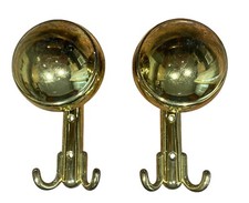 pair of polished brass coat hangers