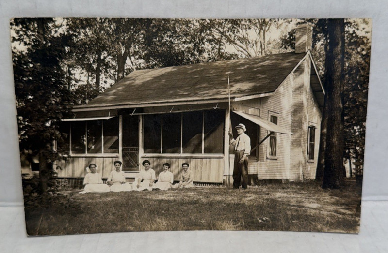 RPPC Real Photo Postcard Old Cabin House Woods Man with a group of Women