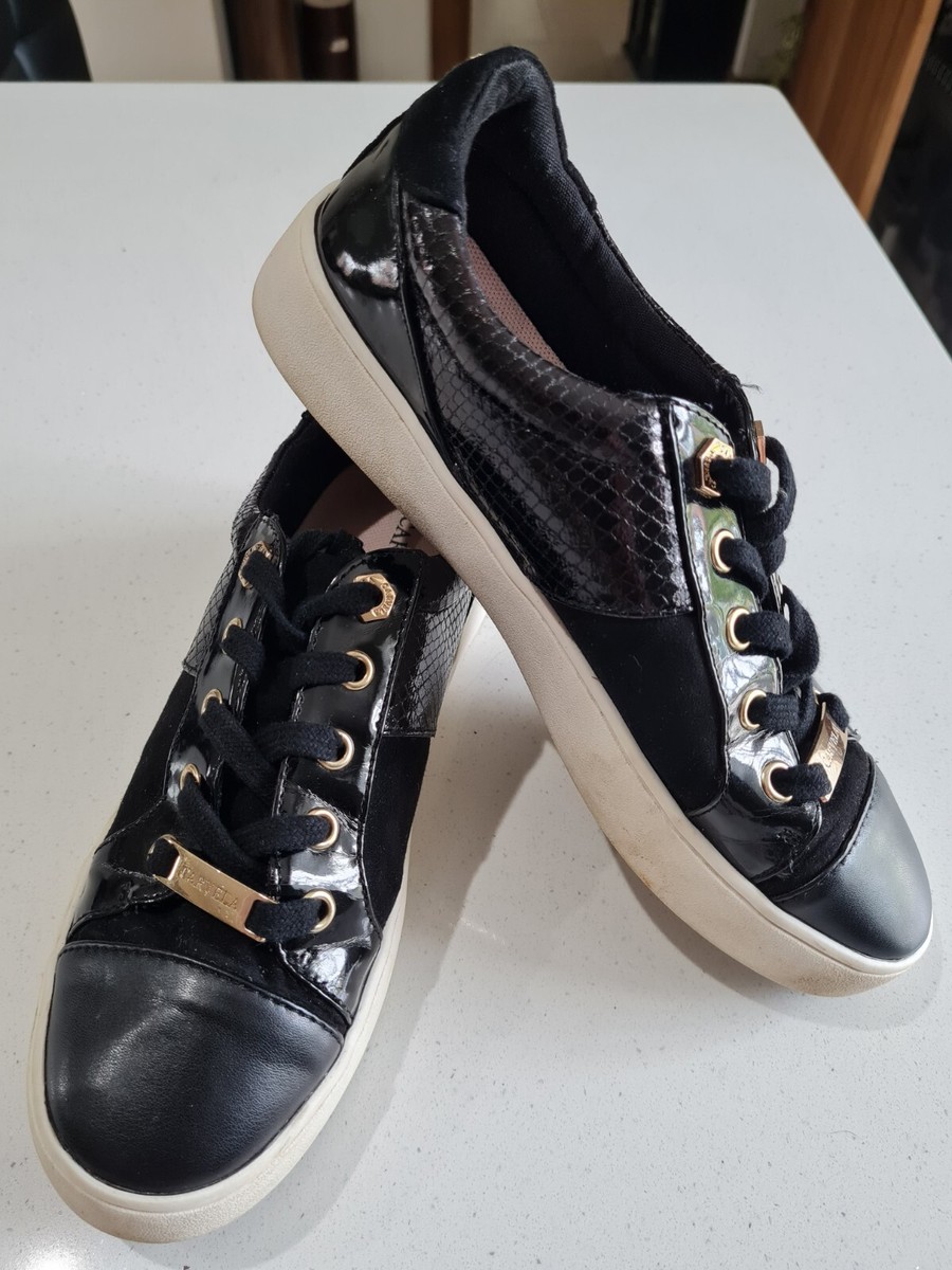 black trainers with gold trim