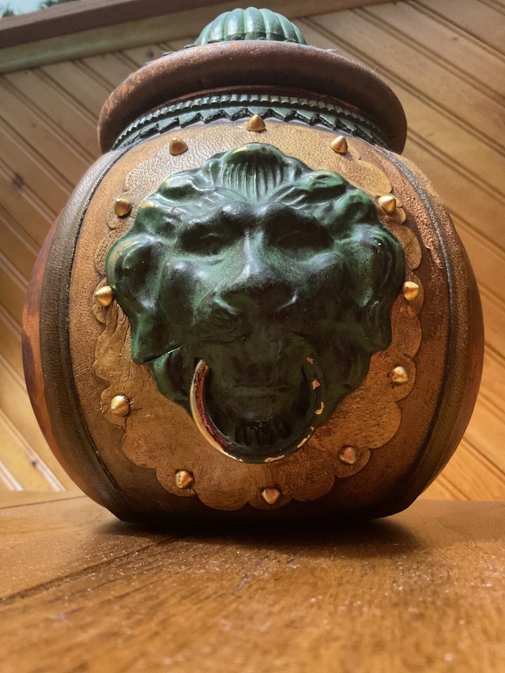 A 1960s Italian leather-wrapped decanter with a lion's-head stopper — a genuinely beautiful, one-of-a-kind piece of Old World craftsmanship.