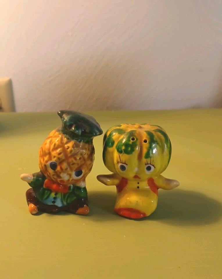 Kitschy mid-century anthropomorphic salt & pepper shakers from Japan — a pineapple and melon with little faces that are peak 1950s tabletop charm.