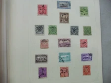 AN OLD STANLEY GIBBONS SIMPLEX BLANK STAMP ALBUM WITH A COLLECTION OF STAMPS