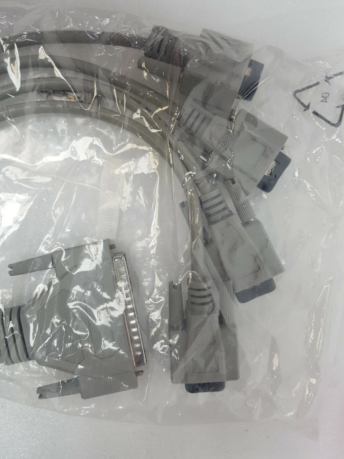 Grey D-sub breakout cable with large and small D-sub connectors in a sealed bag
