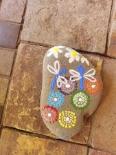 Hand painted Stone featuring dragonflies and daisies