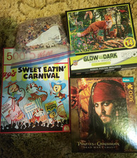 4 Puzzles all used.  300 - 500 pieces each.  1 glow in the dark,  2 Disney