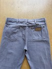 Light gray VTG 90s Wrangler straight leg pants with back pocket and brown leather Wrangler patch on waistband.