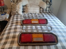 1977 Mustang Ii Tail Lights And Chrome Bezels. One Yellow Lens Has Damage.