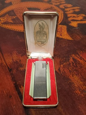 Vintage Hadson rollagas style lighter with Sharp Electronics advertisement....