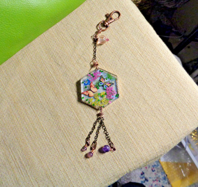 Artisan crafted, 7  long bag charm.Butterflies,flowers and glass glitter in resi