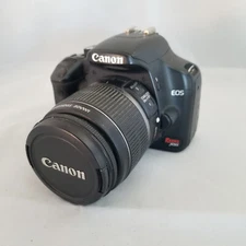 Canon Rebel XSi digital camera with battery.
