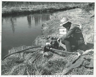 #ad 1964 Press Photo Man putting gas into a portable pump for clean up lrb31928 $24.99
