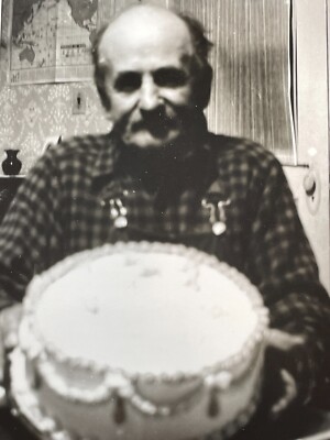A4 Photograph Blurry Close Up POV Old Man Holding Birthday Cake Up For Camera