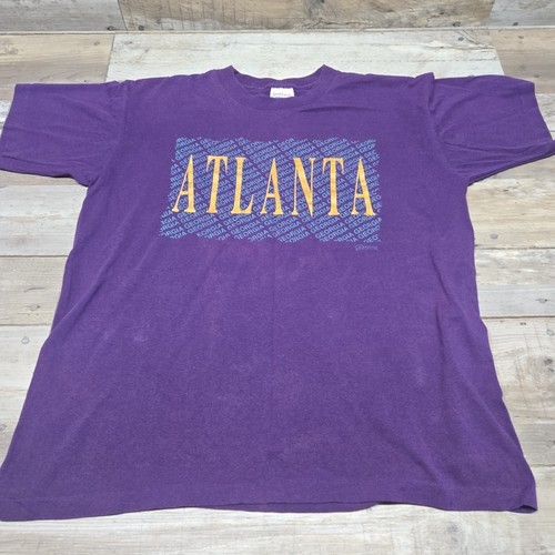 Purple vintage ATLANTA GEORGIA T-shirt with yellow, blue, and white text and partial geometric pattern on front, size L.