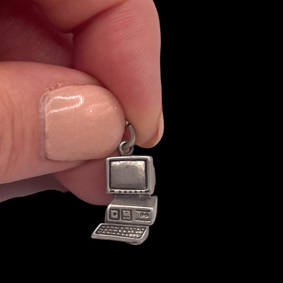 A tiny 925 sterling silver charm shaped like a retro desktop PC keyboard — wearable nostalgia for anyone who grew up clacking on vintage computers.