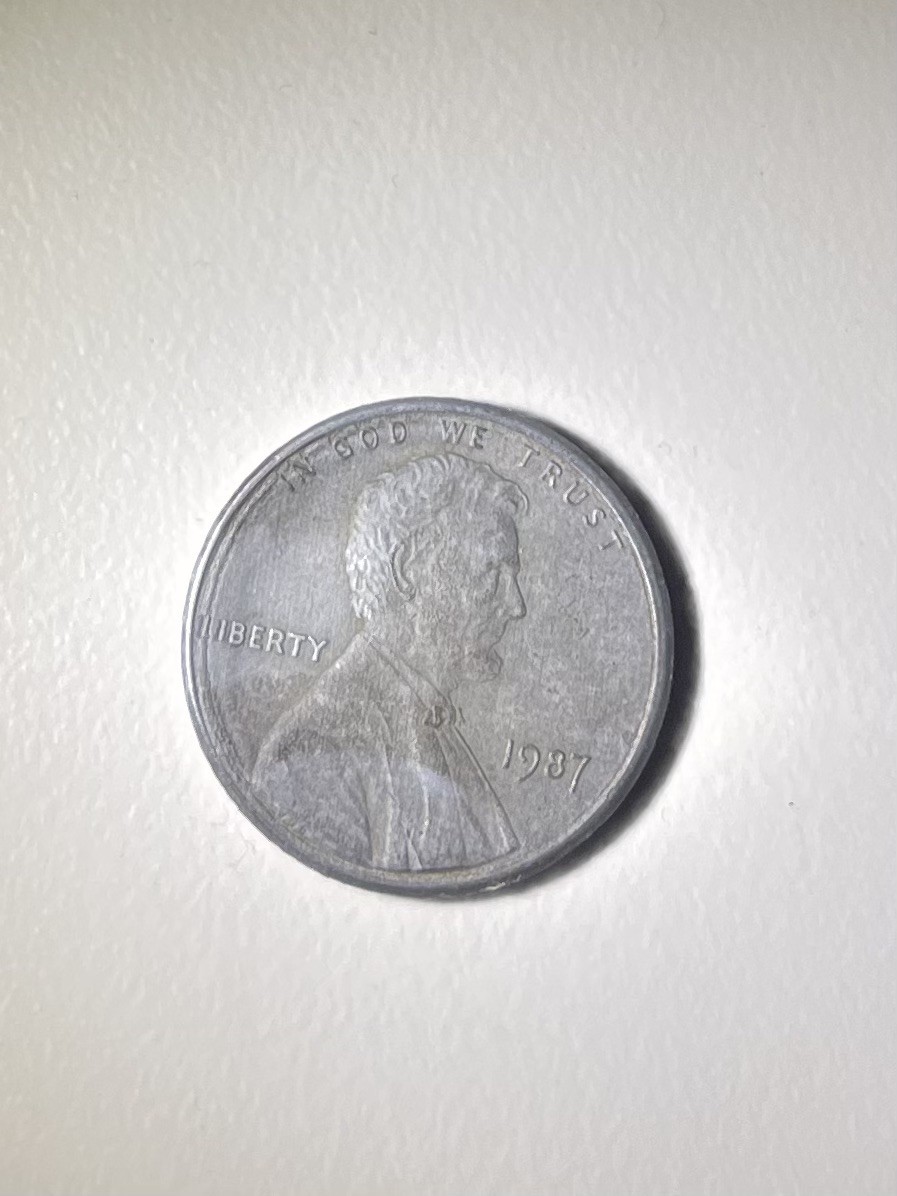 1987 Penny Unplated Planchet. coin that is lacking the copper