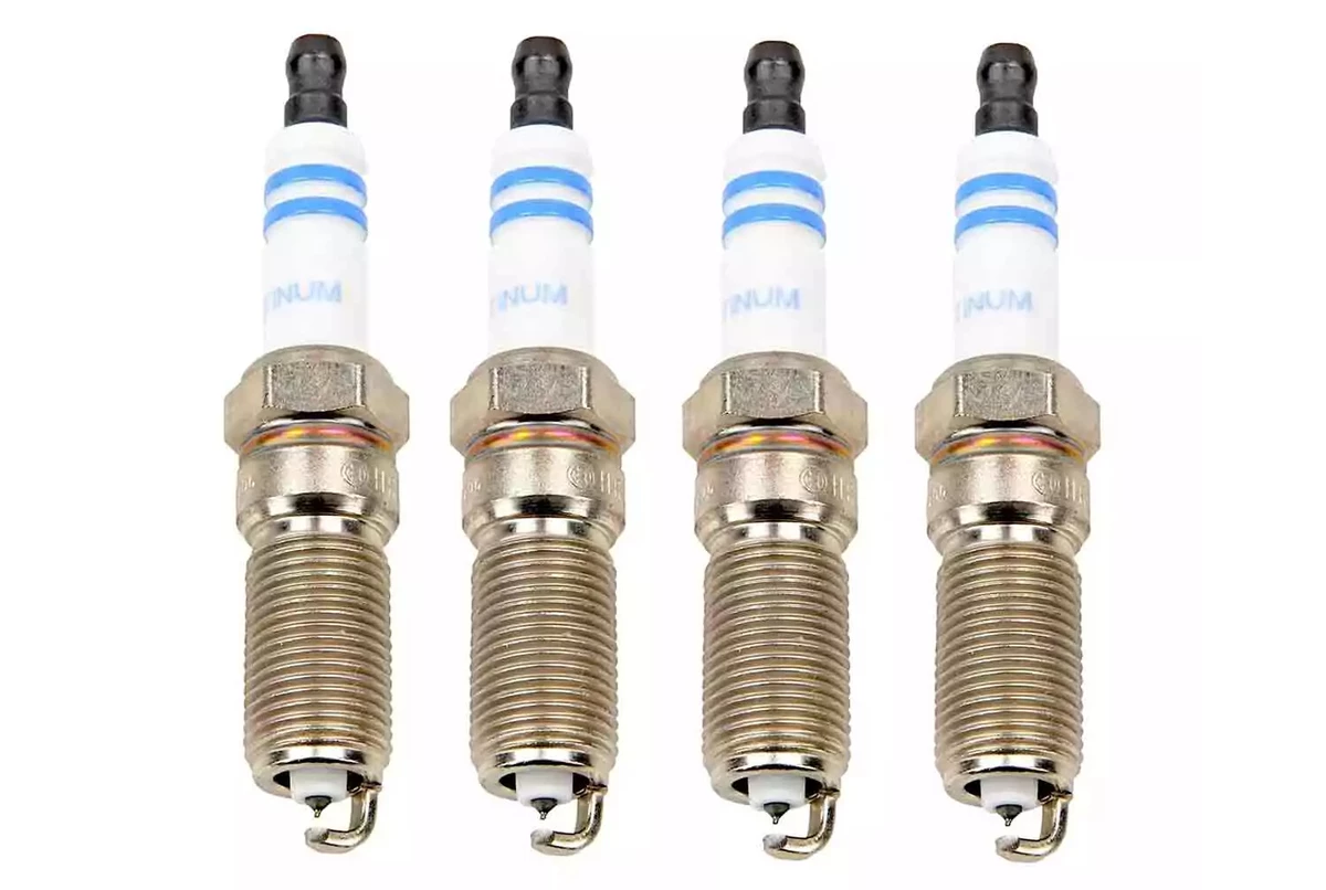 A set of four Bosch platinum spark plugs, displayed on a white surface.