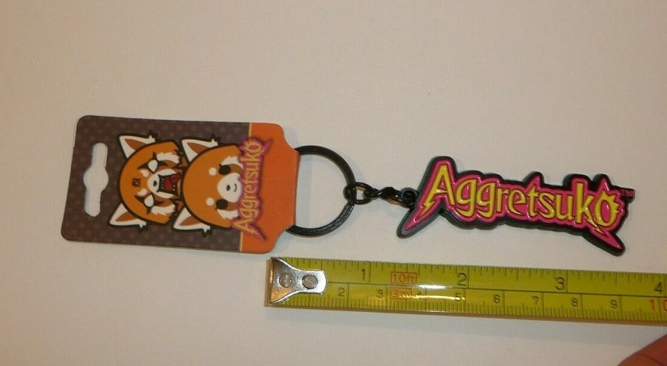 Aggretsuko Title Metal Keychain Key Chain Pink Yellow Word Logo Cat Charm Cute - Image 4 of 4