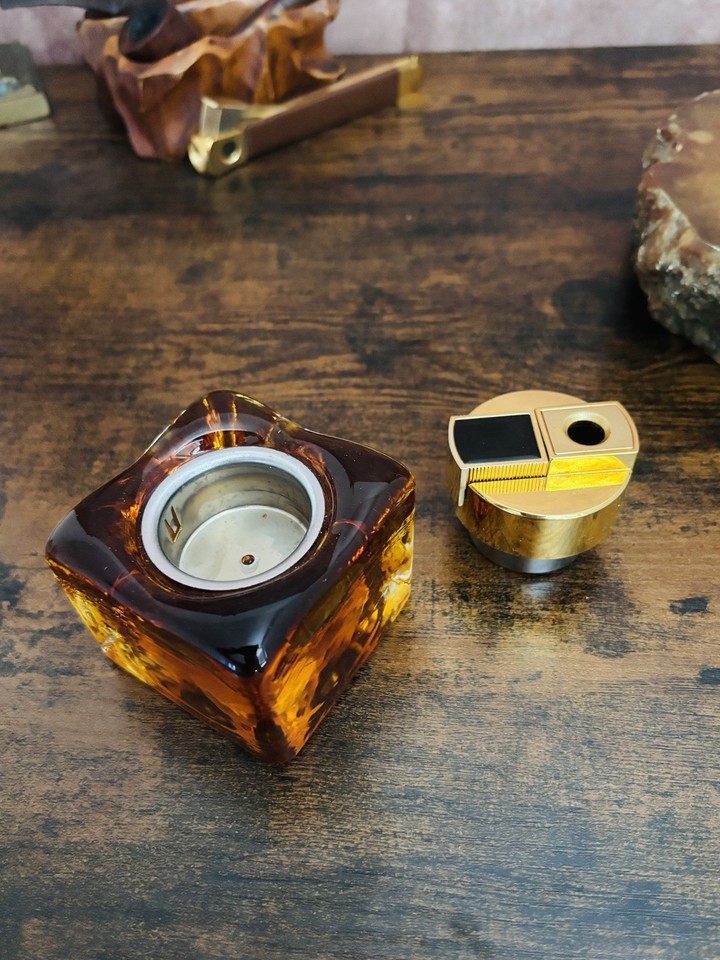 Warm amber glass table lighter with gold tone accents — still working, and looks like a prop from a Mad Men episode.
