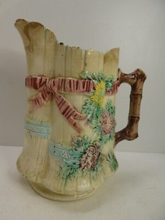 ANTIQUE MAJOLICA EMBOSSED RIBBON BOWS FLORAL BRANCH HANDLE POTTERY JUG