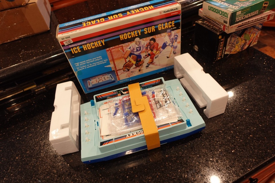 A SEALED, never-opened Radio Shack electronic tabletop hockey game from the golden age of beeping LED sports games — this is a genuine time capsule.