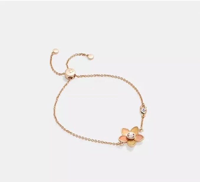 Juego de pulsera deslizante y pendientes Huggie transparentes de flores silvestres COACH Foto 2 de 4