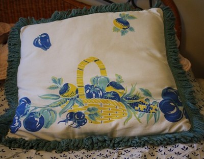 Handmade decorative pillow made from vintage 1940s material with teal fringe
