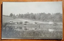 cabins on edge of a pond, pleasant scene unknown location rppc postcard