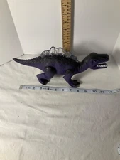 Toy purple dinosaur growls and walks Top lights Working