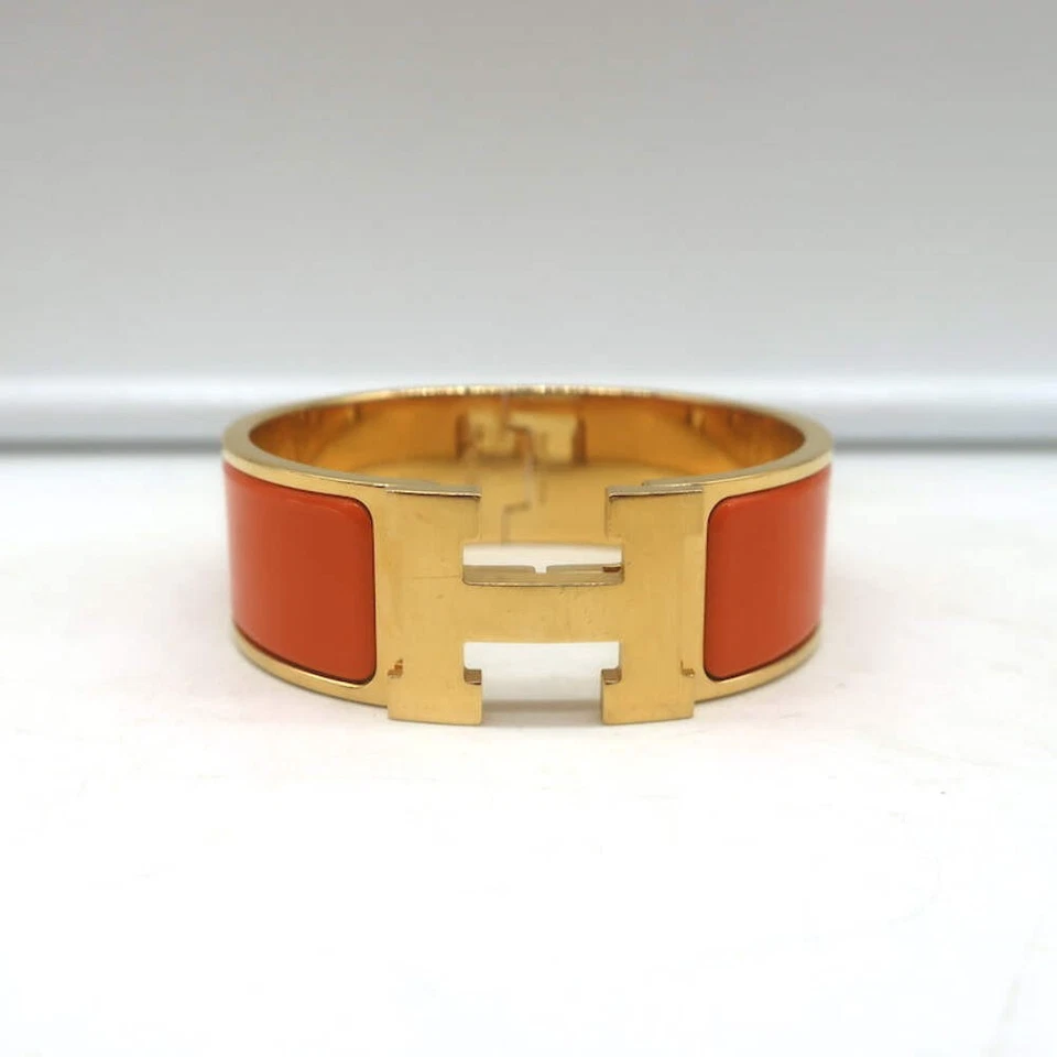 Pulsera Hermes Clic Clac H PM Esmalte Naranja y Oro Foto 2 de 4