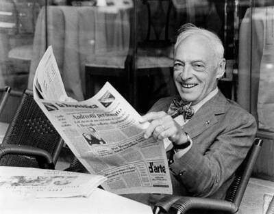 Writer Saul Bellow smiles while he is reading La Repubblica se- 1984 Old Photo
