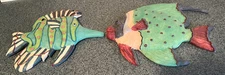 A PAIR OF RESIN HAND PAINTED WALL HANGING FISHES